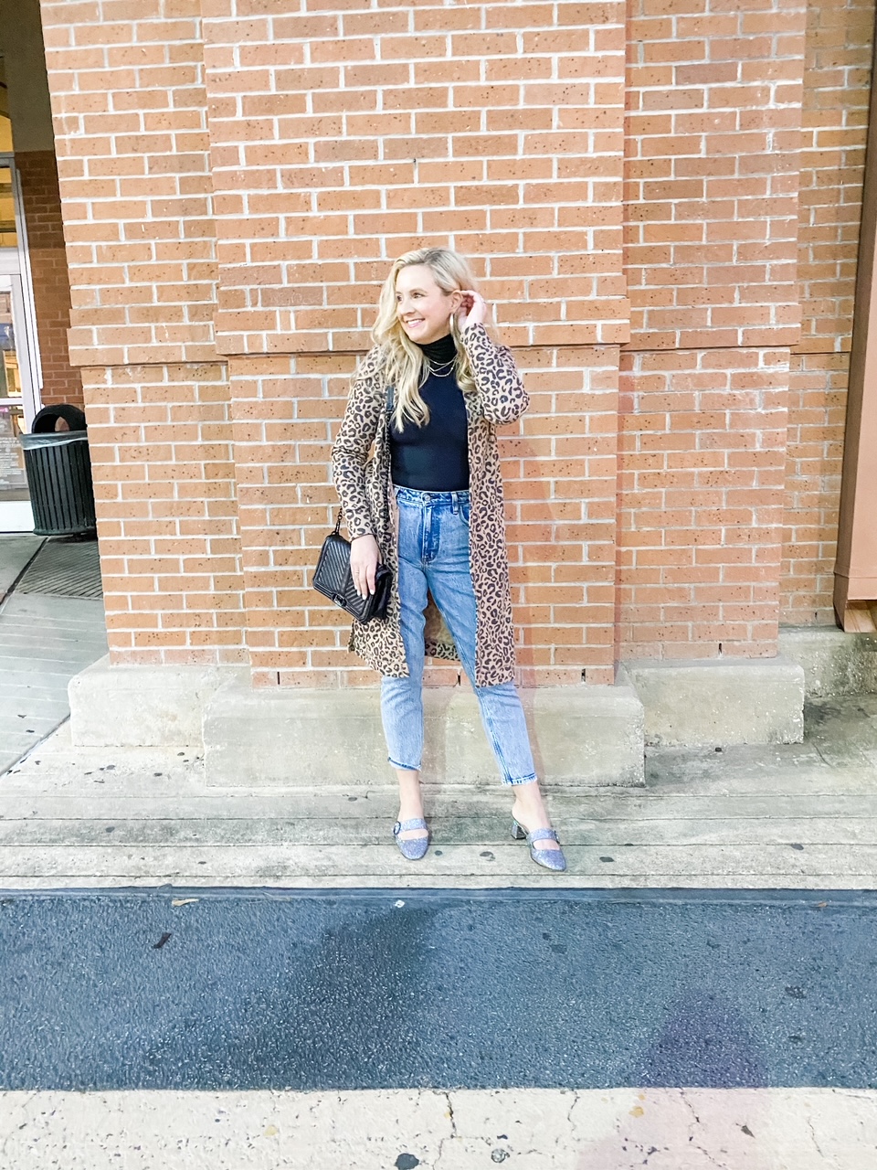 Like To Know It by popular Houston life and style blog, Fancy Ashely: image of a woman wearing a leopard print duster, black bodysuit, jeans, and SJP shoes. 