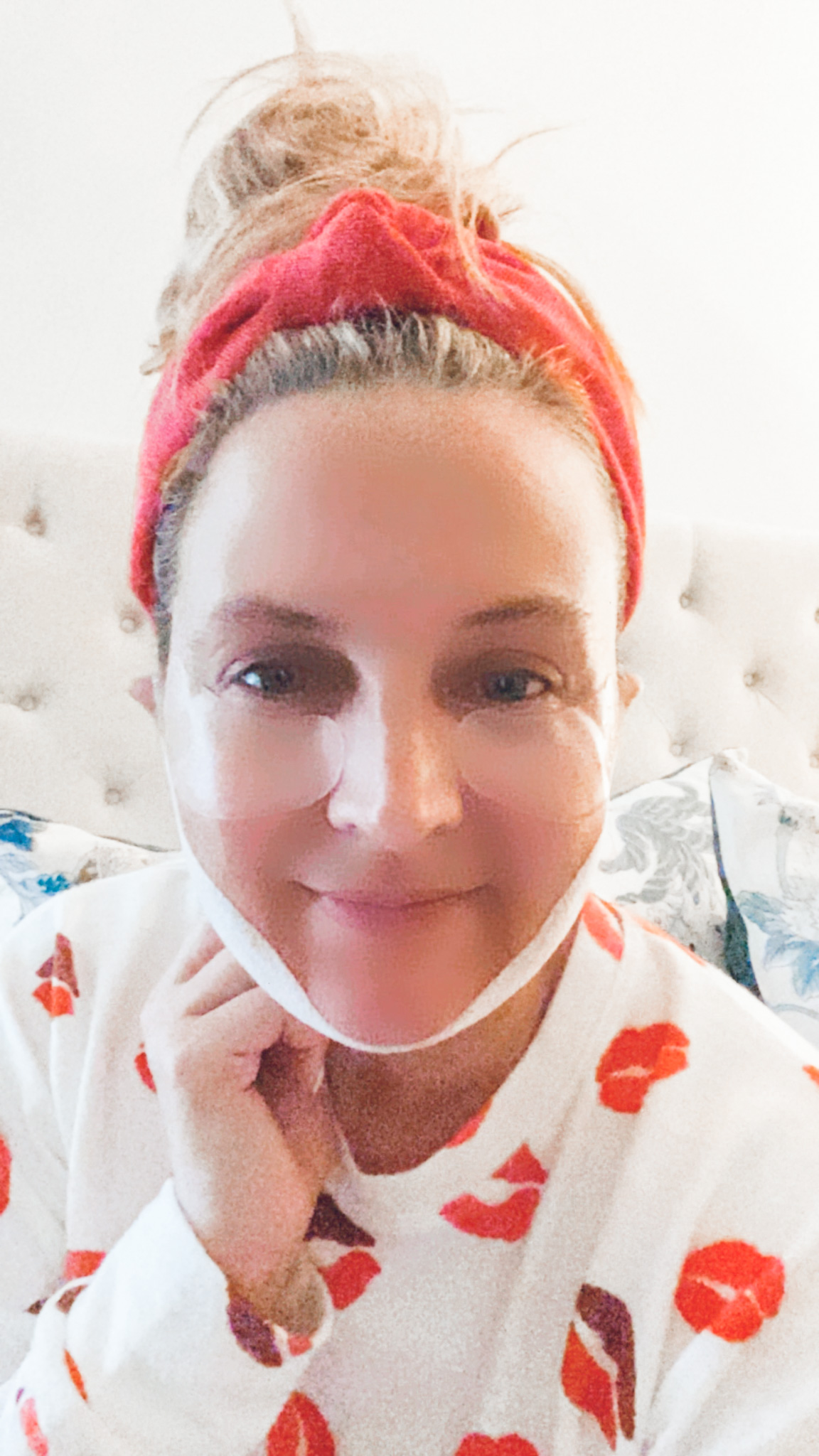 Like To Know It by popular Houston life and style blog, Fancy Ashely: image of a woman wearing a collagen neck mask, Elemis eye masks, red knot headband, and red lip print shirt. 