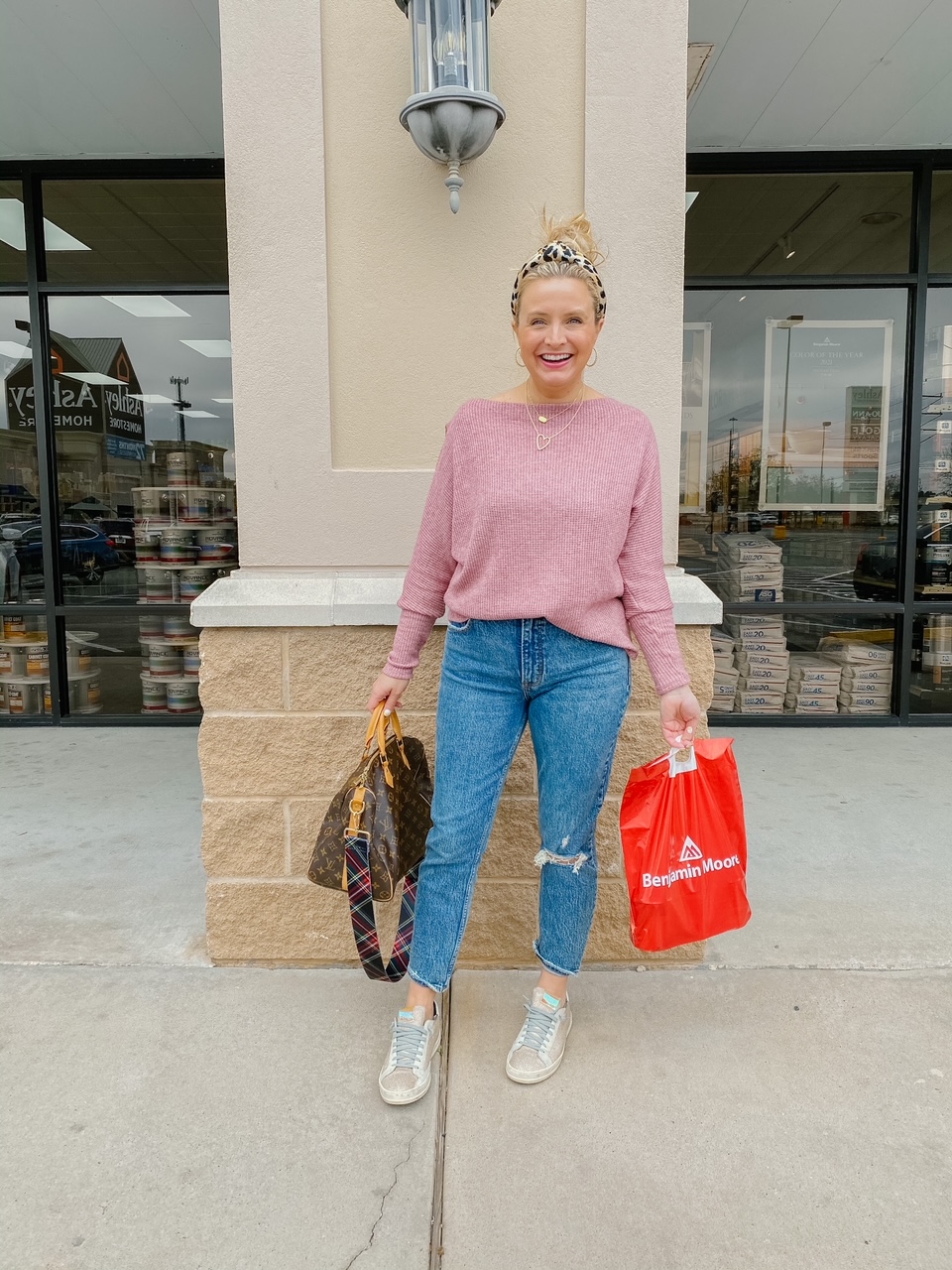 Like To Know It by popular Houston life and style blog, Fancy Ashely: image of a woman wearing a pink sweater, distressed denim, white sneakers, leopard print knot headband and holding a Louis Vuitton bag. 