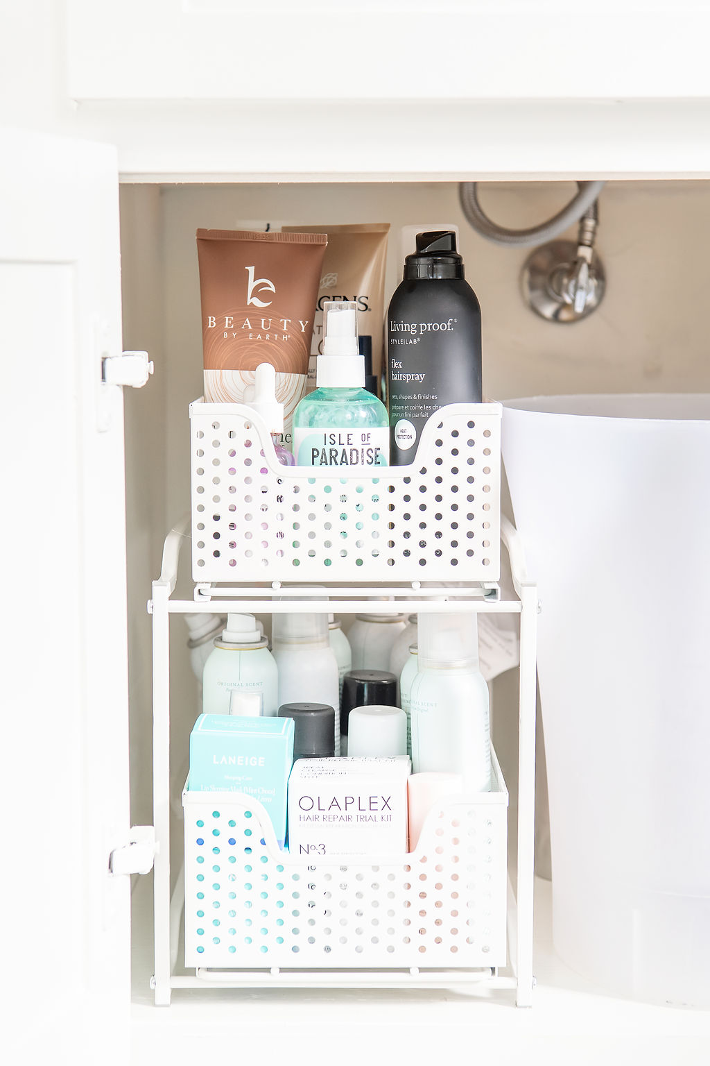 Under Bathroom Sink Organization by popular Houston lifestyle blog, Fancy Ashley: image of a bathroom under sink cabinet organize with a 3 drawer systems and a clear garbage can. 