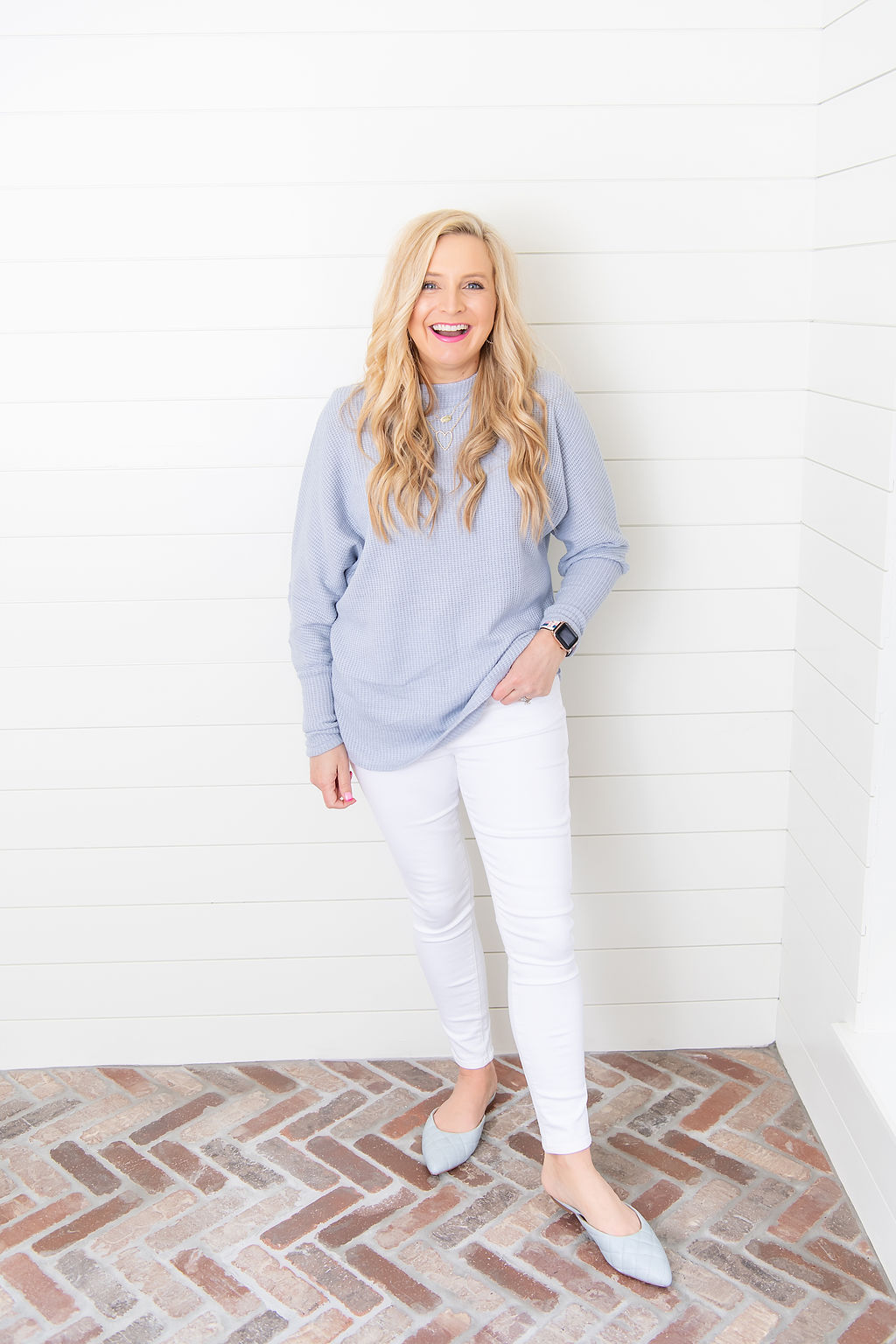 International Women's Day with Gibson by popular Houston fashion blog, Fancy Ashley: image of a woman wearing a Fancy Ashley sweater with a pair of white jeans. 