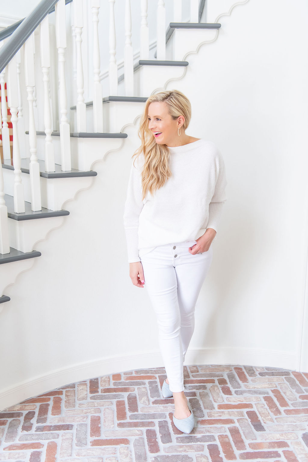 International Women's Day with Gibson by popular Houston fashion blog, Fancy Ashley: image of a woman wearing a Gibson Fancy Ashley sweater with a pair of white jeans. 