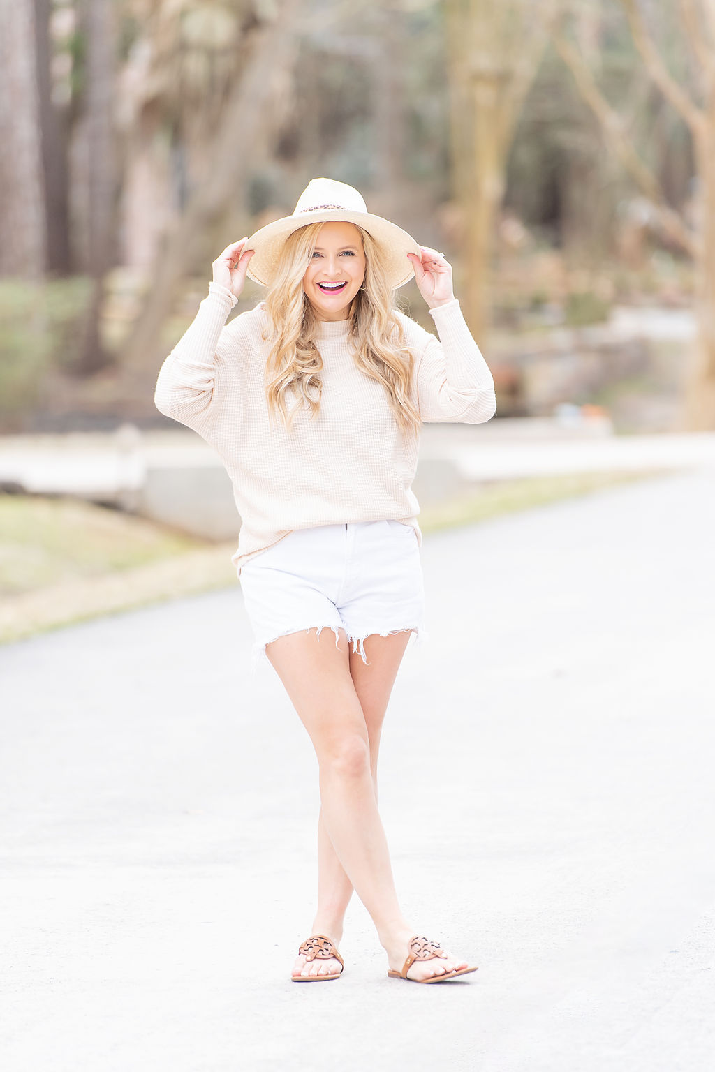 International Women's Day with Gibson by popular Houston fashion blog, Fancy Ashley: image of a woman wearing a Gibson cream Fancy Ashley sweater with white cut off shorts, thong toe sandals and cream hat. 