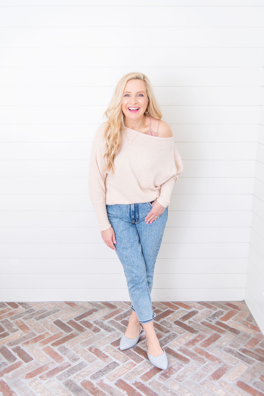 Spring Denim guide by popular Houston fashion blog, Fancy Ashley: image of a woman wearing a pair of denim jeans, blue point toe shoes, and a off the shoulder sweater. 