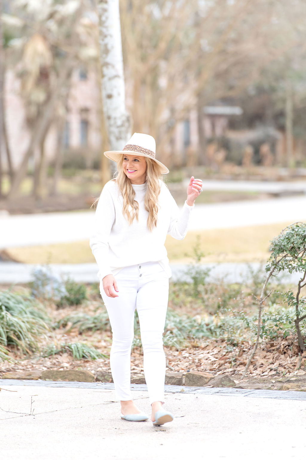 International Women's Day with Gibson by popular Houston fashion blog, Fancy Ashley: image of a woman wearing a Gibson white Fancy Ashley sweater with white jeans and a cream fedora hat. 