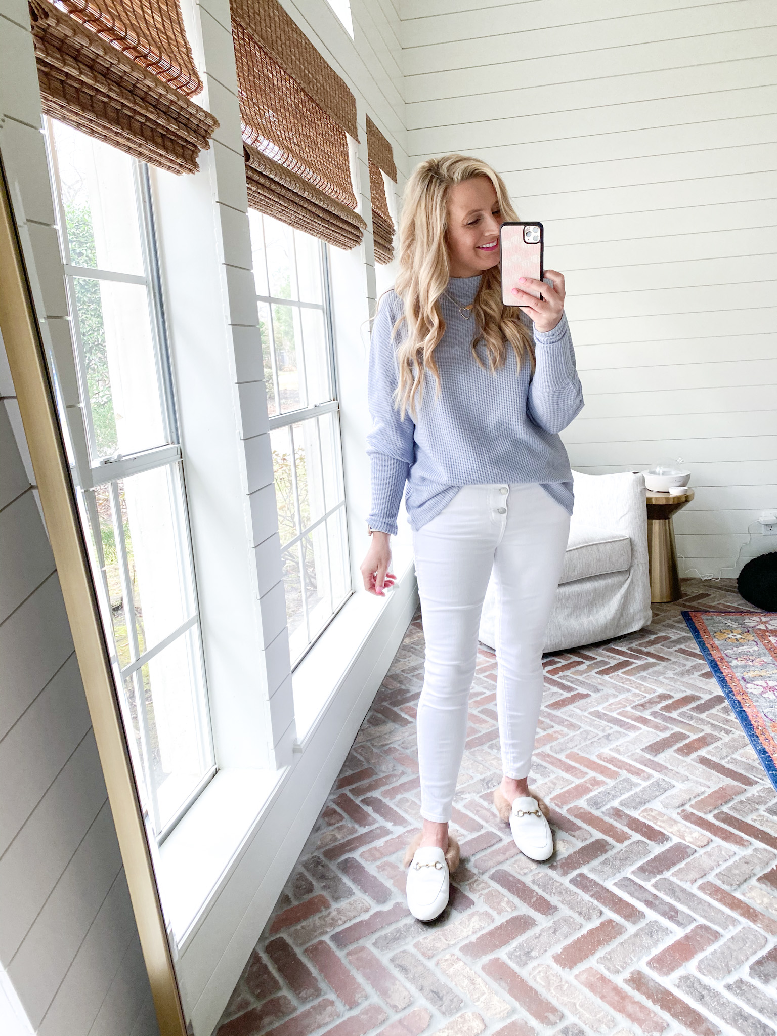 Fitting Room Finds by popular Houston fashion blog, Fancy Ashley: image of a woman wearing a Gibson grey sweater with white jeans and white fur line mules