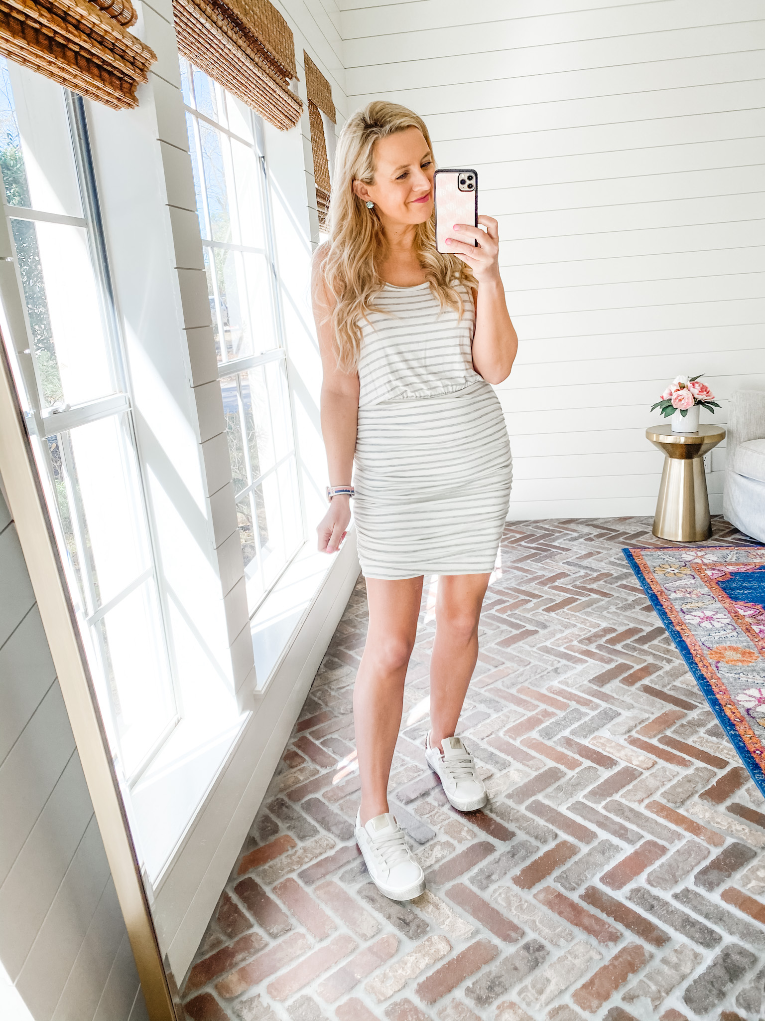 Fitting Room Finds by popular Houston fashion blog, Fancy Ashley: image of a woman wearing a Gibson black and grey stripe tank dress with white sneakers. 