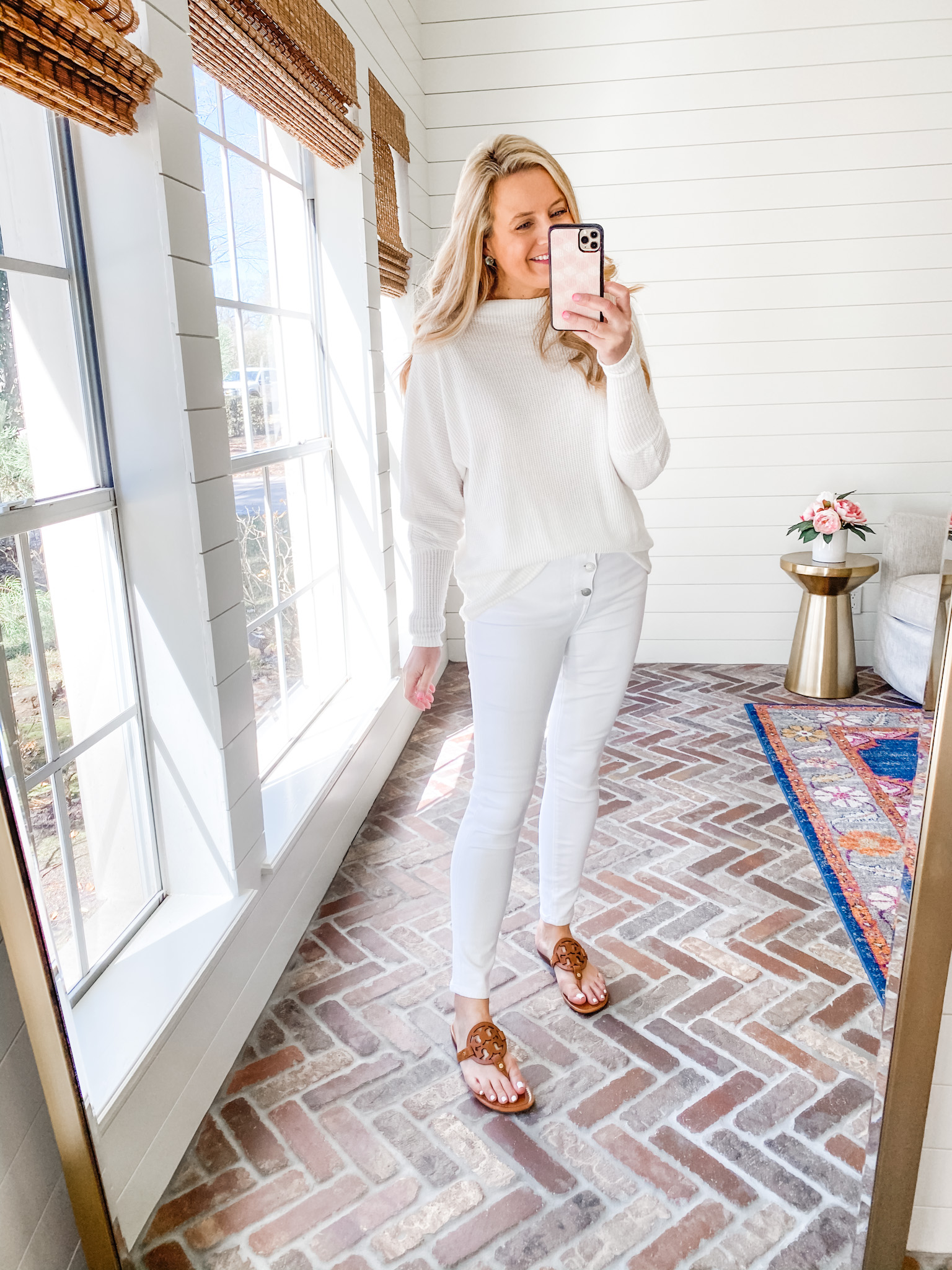 Fitting Room Finds by popular Houston fashion blog, Fancy Ashley: image of a woman wearing a Gibson white sweater, white jeans, brown thong toe sandals. 