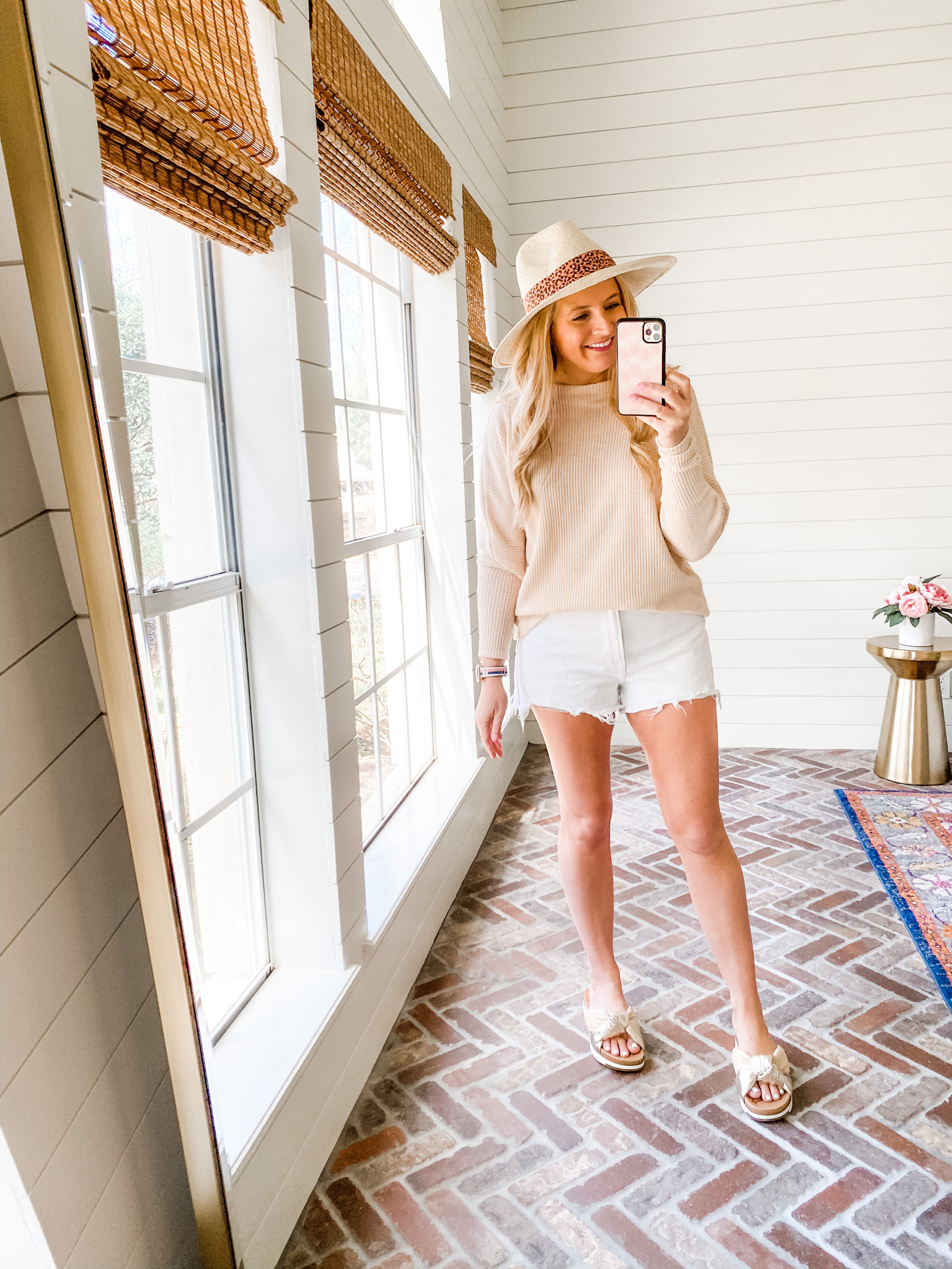 Fitting Room Finds by popular Houston fashion blog, Fancy Ashley: image of a woman wearing a Gibson tan sweater,white cutoff shorts, cream slide sandals, and tan fedora hat. 