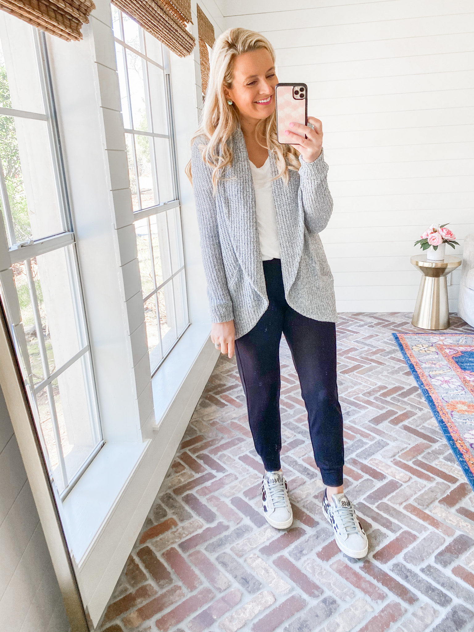 Fitting Room Finds by popular Houston fashion blog, Fancy Ashley: image of a woman wearing a Gibson grey sweater white shirt, black joggers, and white sneakers. 