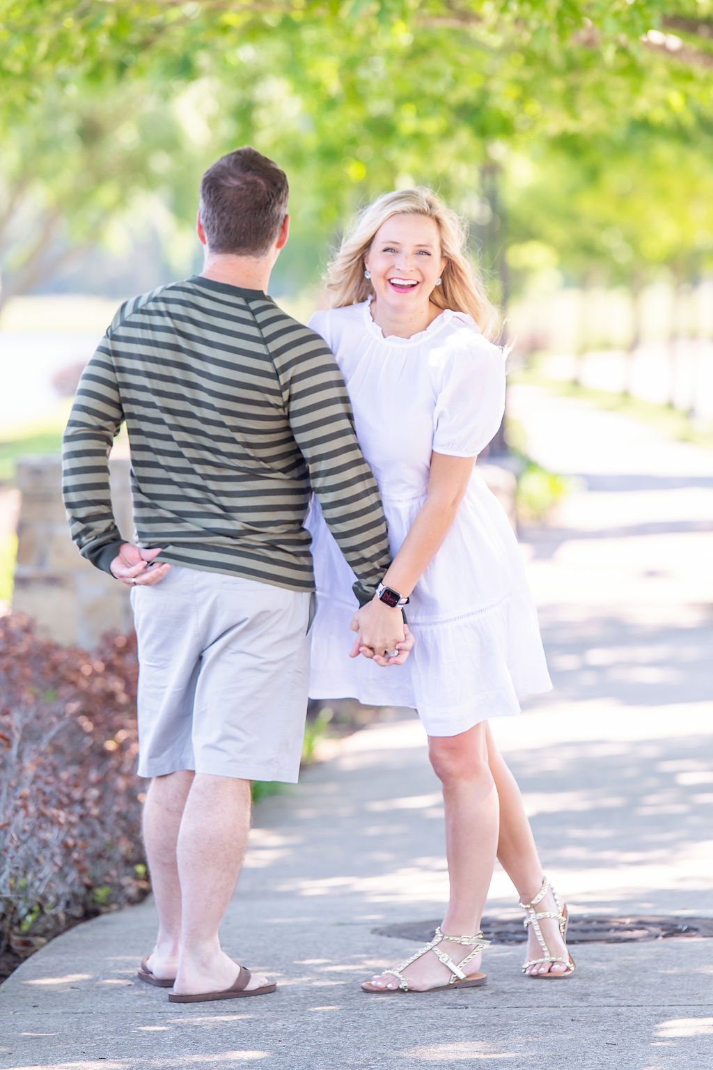 Walmart Summer Fashion by popular Houston fashion blog, The House of Fancy: image of a husband and wife standing together and wearing a white dress, green strip long sleeve shirt and tan shorts. 