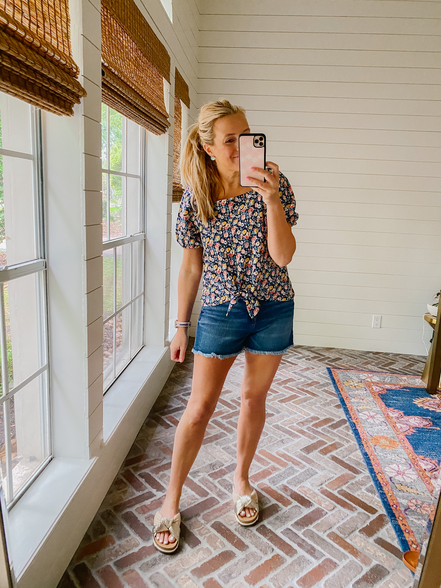 Loft Clothing by popular Houston fashion blog, The House of Fancy: image of a woman wearing a Loft floral print tie front top with distressed hem denim shorts and metallic slide sandals. 