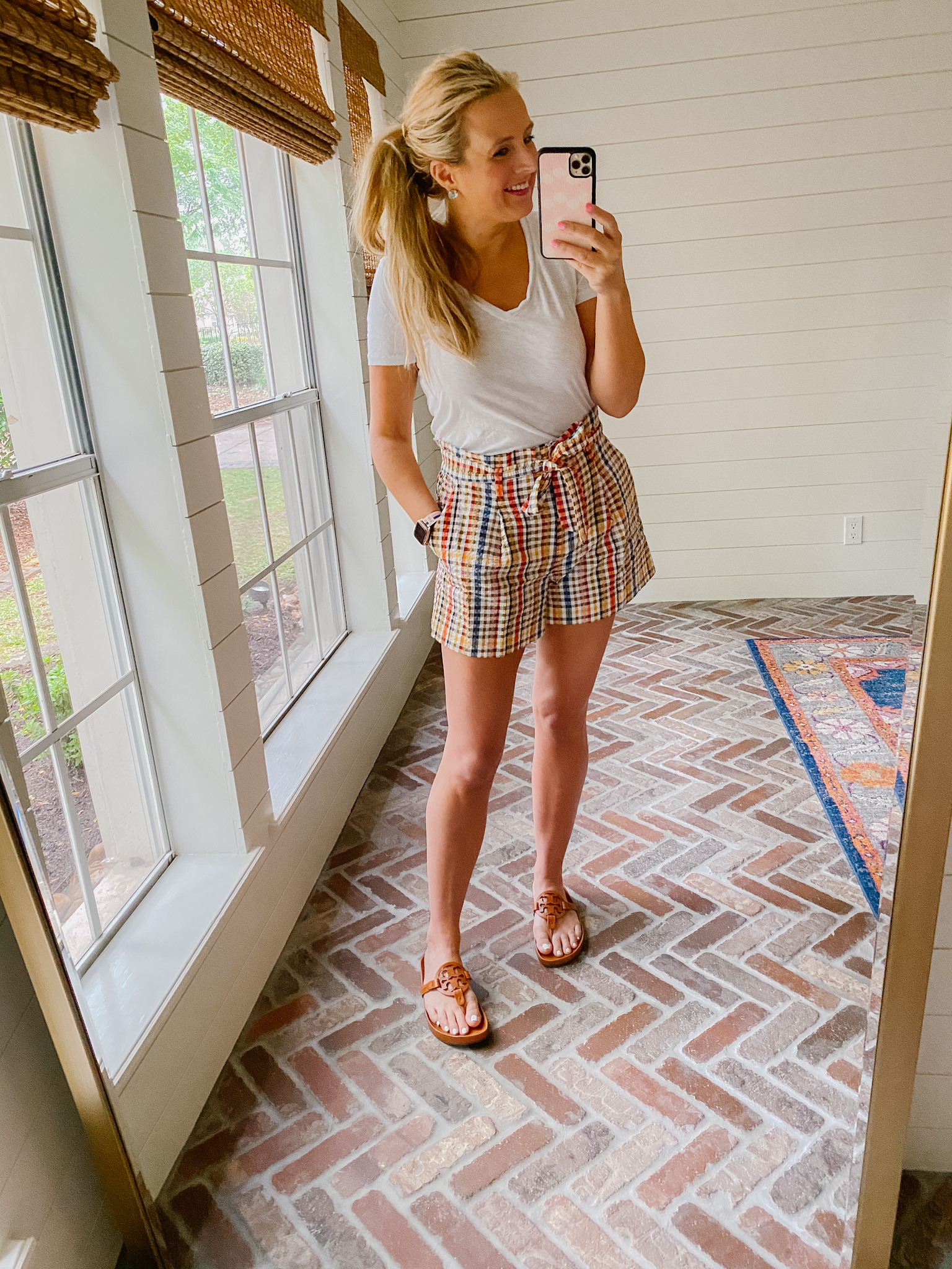 Loft Clothing by popular Houston fashion blog, The House of Fancy: image of a woman wearing a Loft white v-neck tee shirt, plaid paper bag shorts with brown Tory Burch slide sandals. 