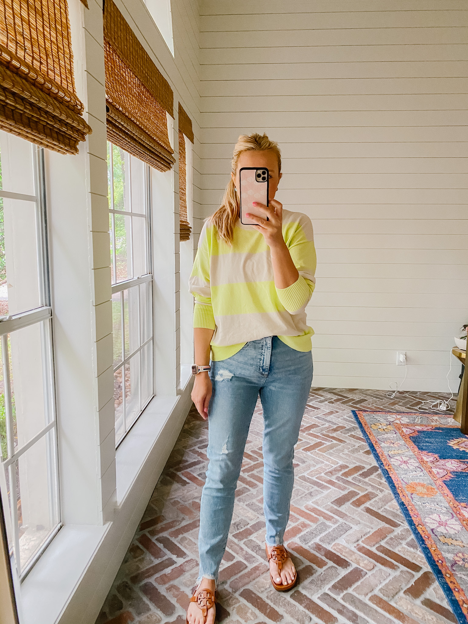 Loft Clothing by popular Houston fashion blog, The House of Fancy: image of a woman wearing a Loft yellow and tan stripe sweater with light wash distressed denim and brown Tory Burch slide sandals. 