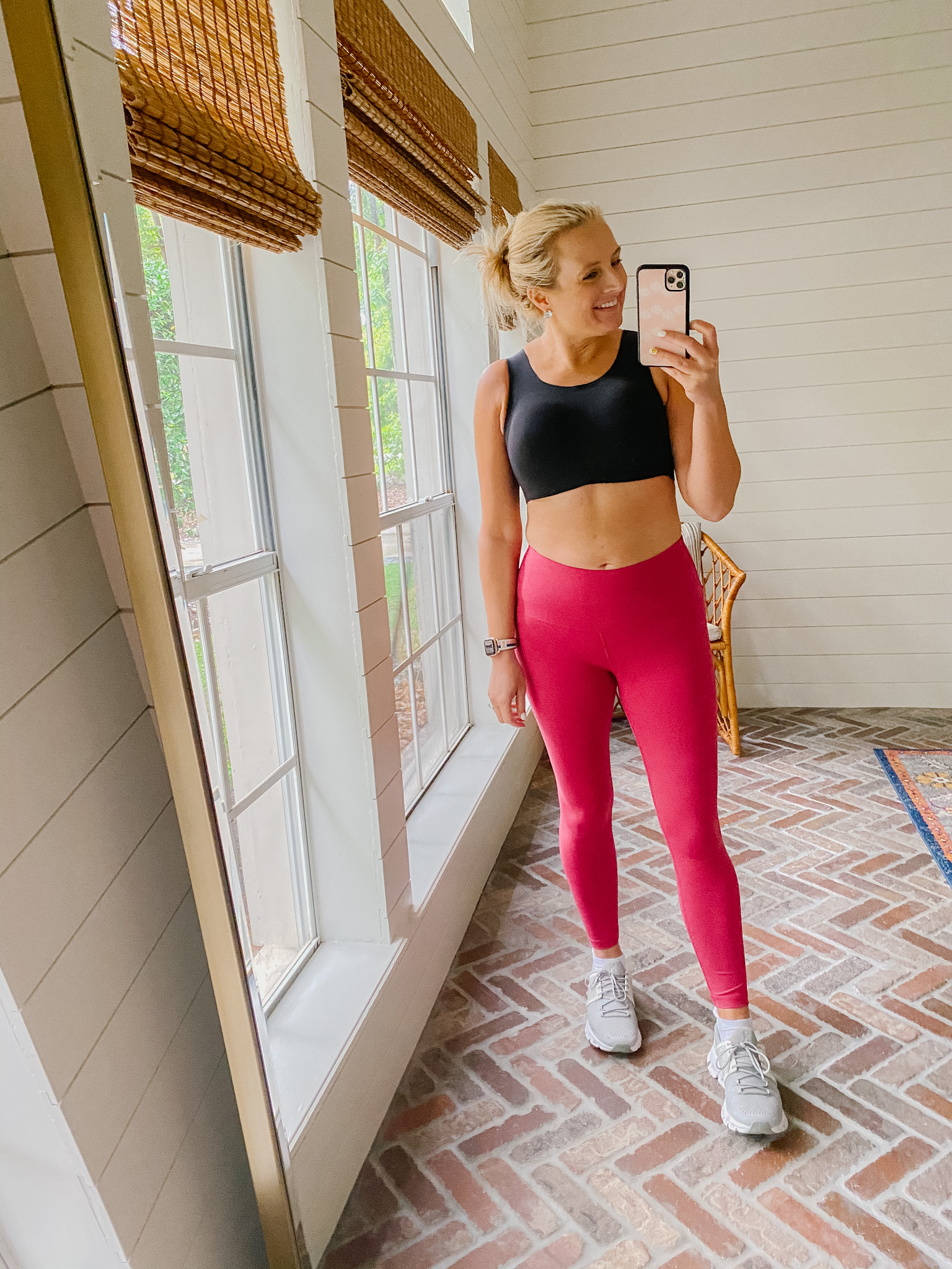 Best Sellers by popular Houston fashion blog, The House of Fancy: image of a woman wearing a black sports bra, pink leggings, and grey athletic sneakers. 