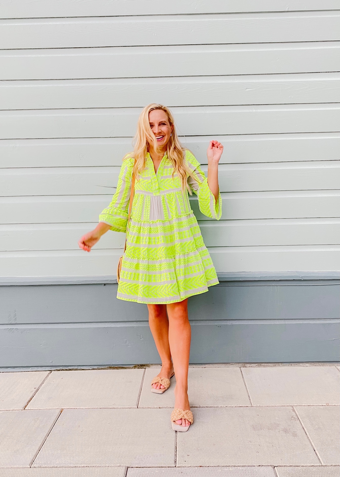 Summer Dress by popular Houston fashion blog, The House of Fancy: image of a woman wearing a yellow embroidered button front and bell sleeve dress and braided strap sandals. 