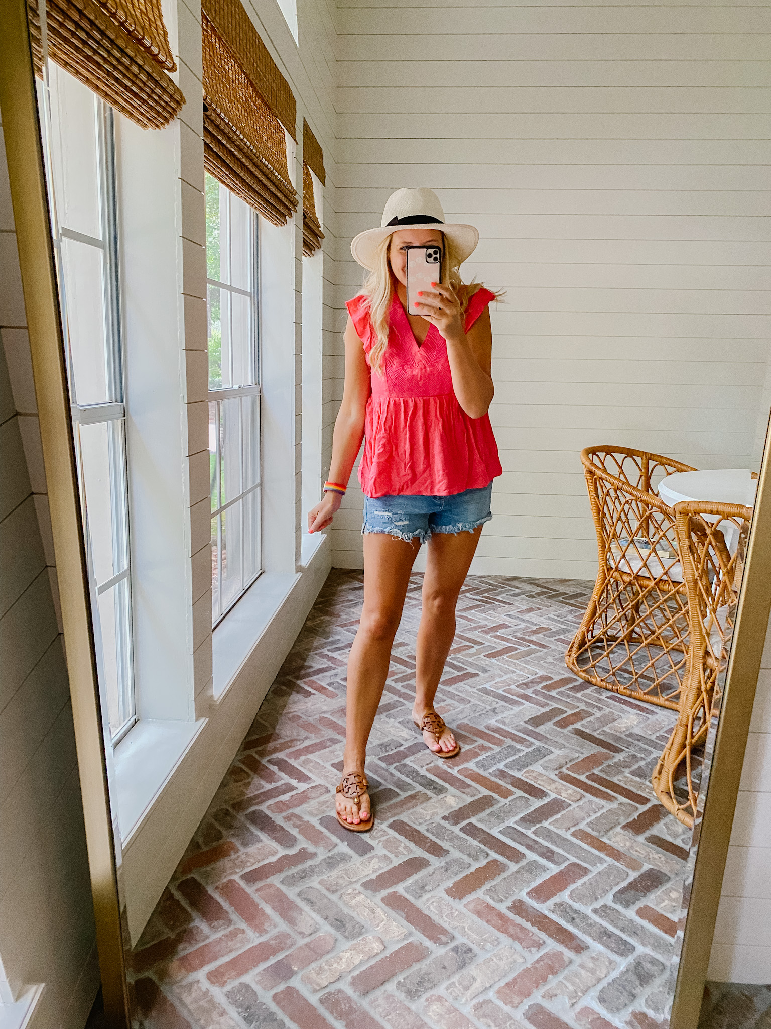 Summer Clothing from Gibson Look by popular Houston fashion blog, The House of Fancy: image of a woman wearing a pink flutter sleeve shirt with frayed hem denim shorts, straw fedora hat, and brown Tory Burch sandals. 