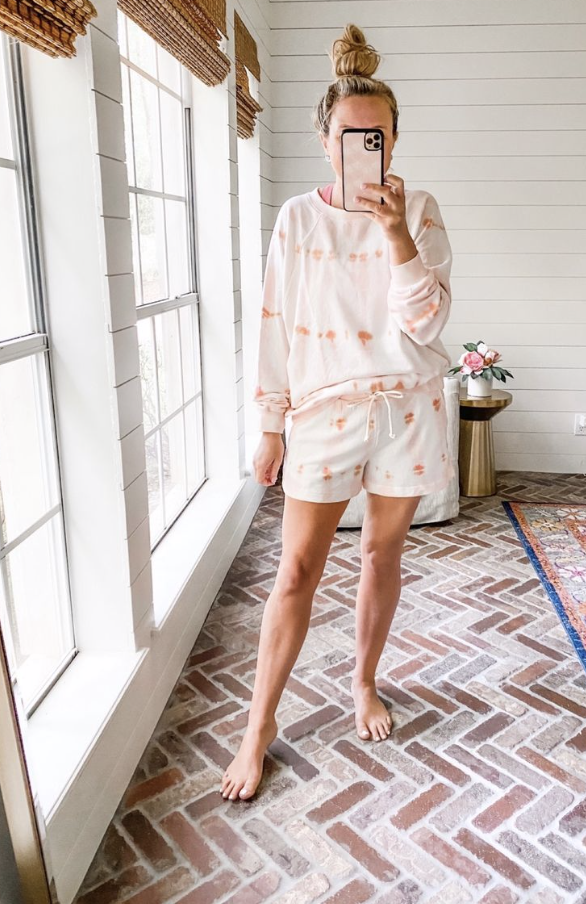 Best Sellers by popular Houston fashion blog, The House of Fancy: image of a woman wearing a pink, orange and white tie dye sweatshirt and shorts set. 