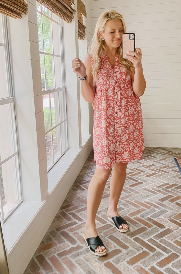 Best Sellers by popular Houston fashion blog, The House of Fancy: image of a woman wearing a pink and white sleeveless button up dress with black cross strap slide sandals. 