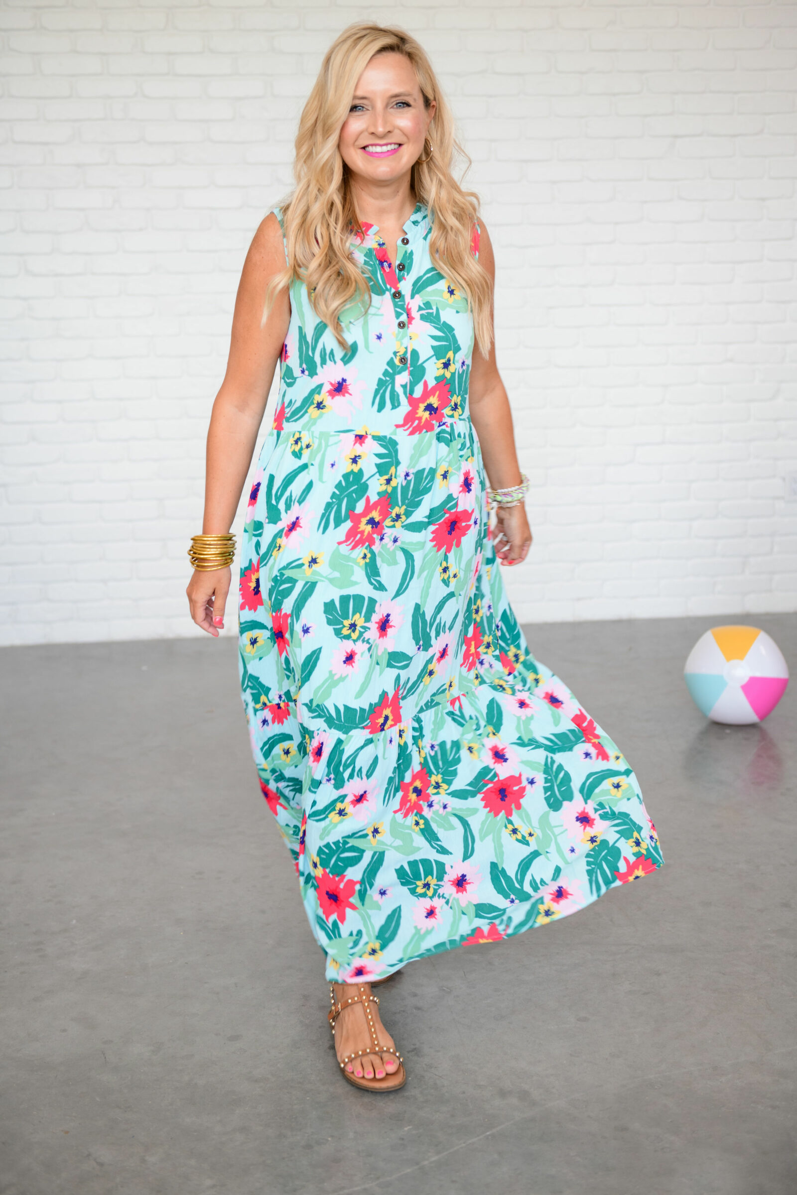 Summer Clothing from Gibson Look by popular Houston fashion blog, The House of Fancy: image of a woman wearing pink and green tropical print maxi dress, gold bracelets, brown studded strap sandals. 