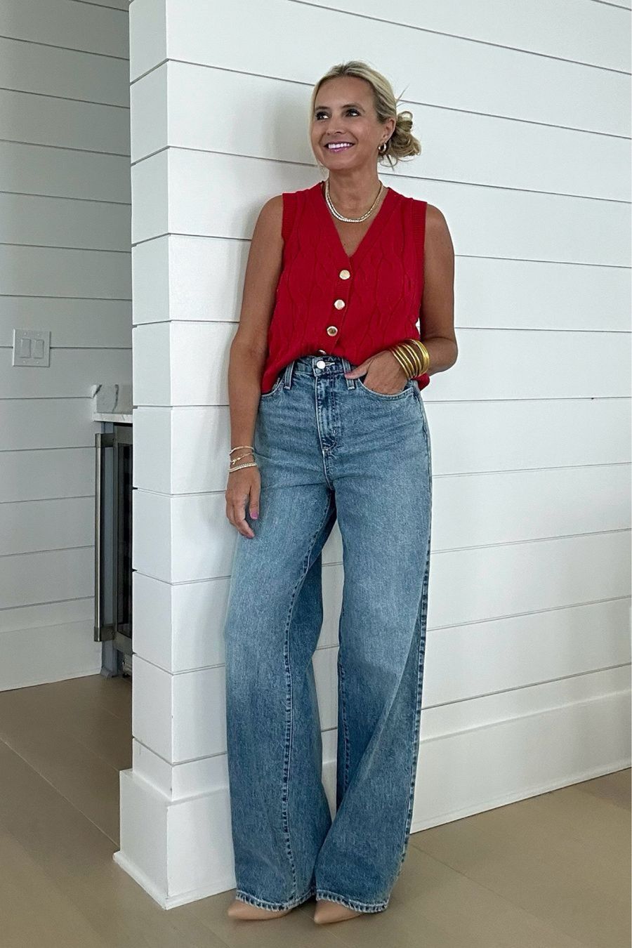 Red sweater vest and jeans